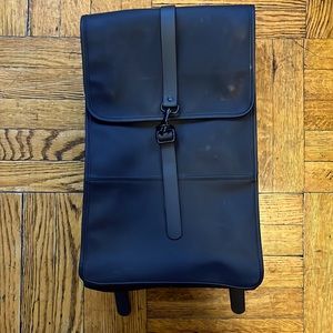 Rains waterproof black backpack.